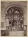 [Carved rood screen in church]