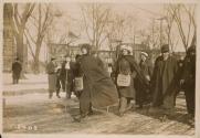 [Women marching during the suffrage hike, with "Votes for Women" bags]