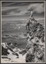 [Man standing on rock formation]