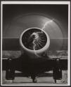 [Front view of plane with propeller running]
