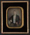 [Seated man wearing jacket and waistcoat]