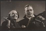 [Couple smoking in car with starry sky in background]