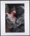 US Army Flight Medic talks to a soldier wounded by an IED in a medevac helicopter, Kandahar, Afghanistan