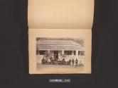 [Group portrait in front of decorated building]