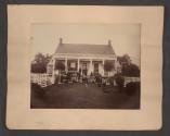 [Students in front of schoolhouse \ Family in front of house]