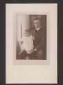 [Man with baby on lap]