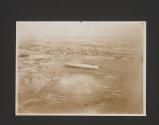 [Aerial view of the USS Shenandoah on the ground]