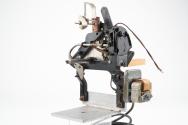 Mechanism for tin box style mutoscope