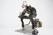 Mechanism for tin box style mutoscope