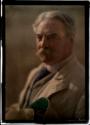 [Man with white hair and moustache in suit]