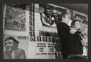 Norman Mailer speaking, view of mayoral campaign posters, New York City