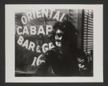 Man in front of Oriental Bar and Grill