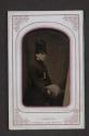 [Woman wearing tall hat and muff]
