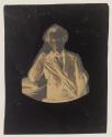 [Man, seated with head supported on arm, elbow on book placed on a column]