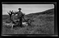 George B. Dryden with dead caribou, Alaska trip