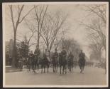 [Snapshot of officers on horses in parade]
