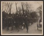 [Snapshot of officers and soldiers in parade]
