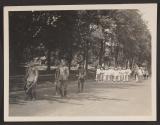 [Snapshot of military officers with canes in parade]