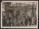 [Snapshot of Major Barnes on horse in parade]