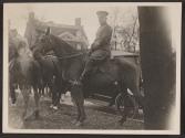 [Snapshot of military officer on horse]