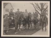 [Snapshot of military officers on horses]