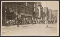 [Snapshot of officers on horses in parade]