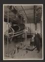 [Man standing next to cockpit simulator (Link Trainer), U.S. Army School of Aerial Photography, Rochester]