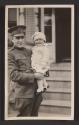 [Snapshot of military officer holding child]