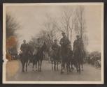 [Snapshots of officers on horses in parade]