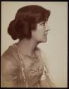 [Young woman (profile) with hair rolled up]