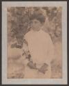 [Boy holding branch of apple tree]