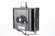 Strut folding hand camera