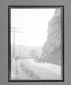 [auto on country road by cliff]