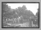 [Man on wood pile with other people nearby]