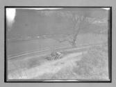 [auto driving by river]