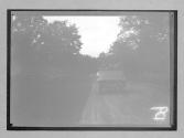 [back of auto driving in country]