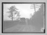 [auto racer talking- parked auto country road]