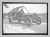 [two men in auto "The Acme"]