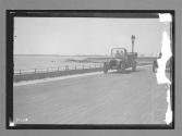 [auto tour "Premier Offical" passing water]