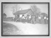 [people in front of auto shed]