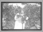 [portrait of woman in garden]