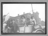 [people in auto in town]