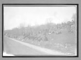 [spectators sitting by road at auto race]