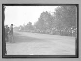 [spectators waiting for racers]