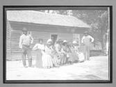 [family in front of cabin]