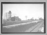[water tower & shack near railroad tracks]