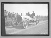 [auto racers passing spectator]