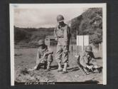 [Cpl. Wilson Bittig (Argo, Illinois), an Infantryman being trained by the engineers as a mine dector opertator. The tapemen with him are S/Sgt Raymond J. Overlay (Battle Creek, Mich.), Left, and CPL Gordon Prunner (Battle Creek, Mich.) 7th Engr Regt, 5th Inf Div., Blackpool Sands, Devon, England.]
