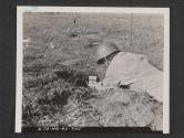 [Sgt. Kenneth Wachtl (Wausau, WIS.) places a demolition charge alongside a mine during maneuvers in England.  7th Eng Regt, 5th Inf Div., Blackpool Sands, Devon, England. ]