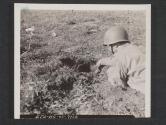[Pfc. John Farko (Amsterdam, O.) uncovers an anti-tank mine before setting it CFF with a demolition charge.  7th Engr Regt., 5th Inf Div, Blackpool Sands, Devon, England]